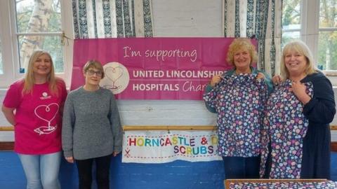 Staff and volunteers with the pyjama gowns