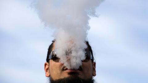 A man vapes during a rally to protest the proposed vaping flavor ban in Washington DC