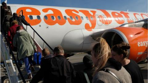 Passengers board an Easyjet flight