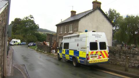 police vehicles outside a house