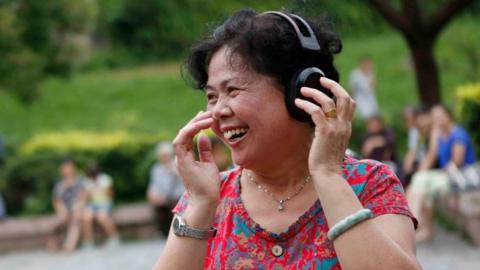 Woman listing to music in China
