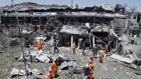 Workers remove debris from a damaged area a day after a suicide bomb attack near foreign embassies in Kabul, Afghanistan, 01 June 2017