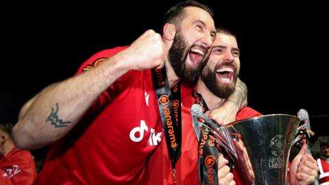 Wrexham's Ollie Palmer and Elliot Lee celebrate with the National League trophy