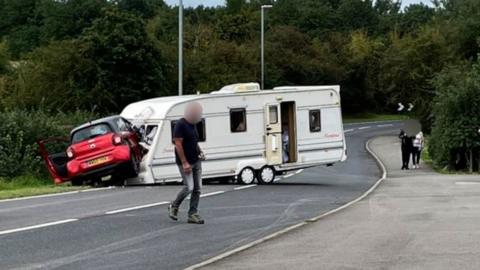 Detached caravan crashes into car