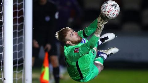 Jason Steele saves a penalty at Rodney Parade