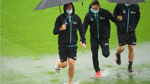 New Zealand players in rain