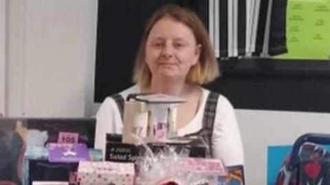 A woman with short hair smiles at the camera