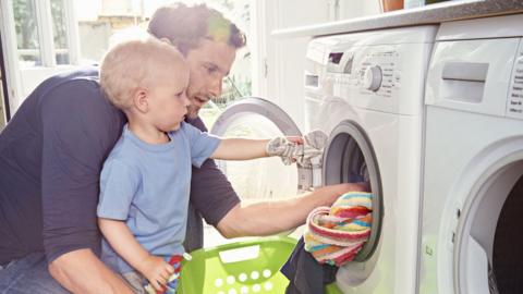 Father and son doing laundry together