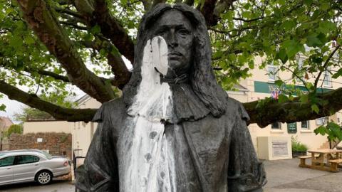 White paint on face and body of Sir George Carteret statue