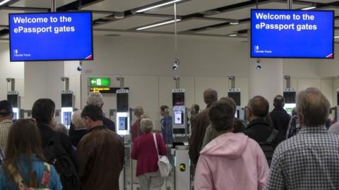 Passengers going through passport control at Gatwick airport