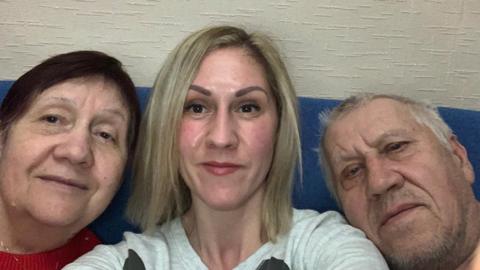 Tanya Noble (centre) with her parents Nataliia and Volodymyr on a recent trip to Ukraine