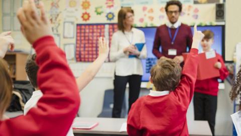 Teachers in front of a class of children