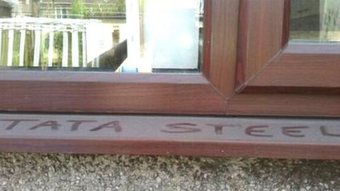 Words Tata Steel written in dust on external window sill at Port Talbot home of Peter Davies