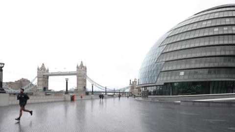 Man runs outside City Hall in London