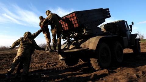 File photo shows Ukrainian artillery troops operating a multiple rocket launcher