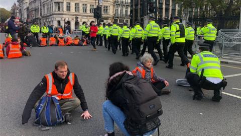 Police walk around protesters