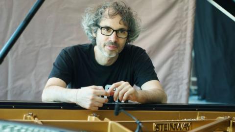 James Rhodes sitting at a piano in Madrid, 2018