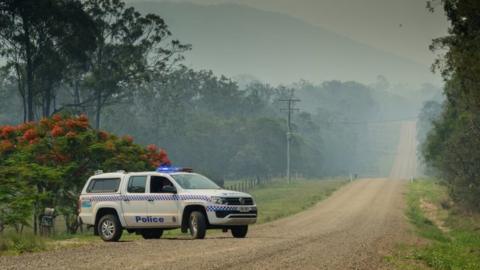 Police block off road to check houses in area affected