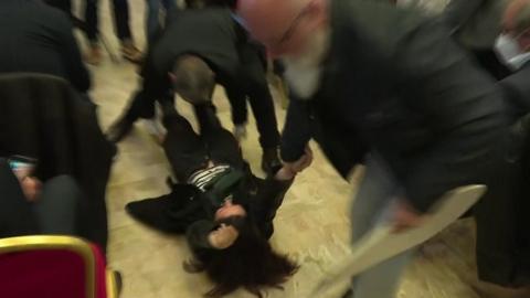 Protester dragged from news conference