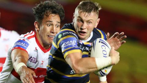 Leeds Rhinos tryscorer Harry Newman takes on Nate Peteru