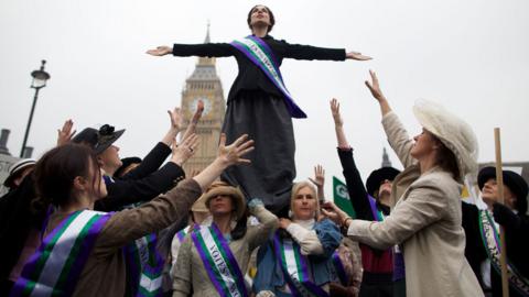 October 24, 2012: Feminist activists dressed as The Suffragettes, women who historically demanded the right to vote, protest at Parliament Square for women"s rights and equality in Parliament Square, London