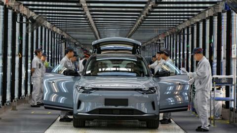 Employees work on the assembly line of new energy vehicles at a factory of Chinese EV startup Leapmotor on April 1, 2024 in Jinhua, Zhejiang Province of China