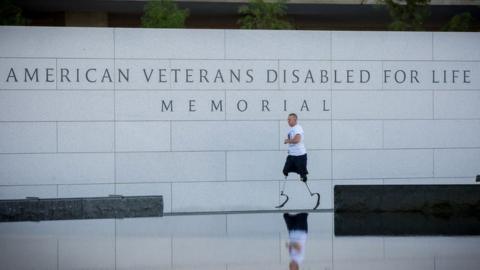 Rob Jones running around a disabled veterans memorial