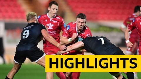 Scott Williams of the Scarlets is tackled by Jac Morgan of the Ospreys