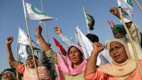 Women shout slogans at an expressway which was blocked by farmers to mark the 100th day of the protest against the farm laws, near Kundli border, in Haryana, India, March 6, 2021