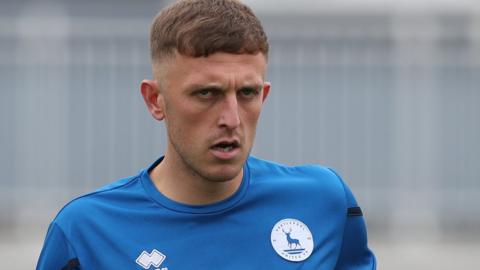 Oliver Finney warms up in Hartlepool's pre-match preparations