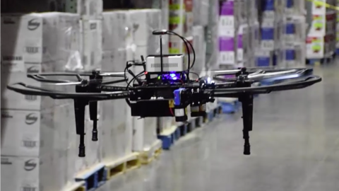 Flying drone scanning warehouse packages