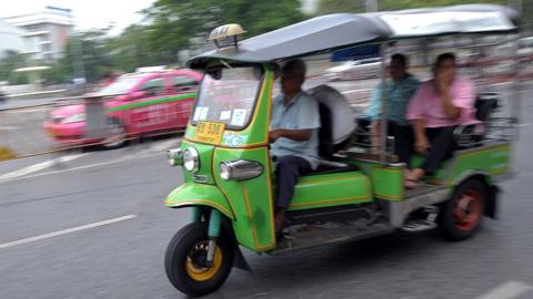 Passengers are transported on a 'Tuk-tuk' at the central Bangkok on 20 January 2010.