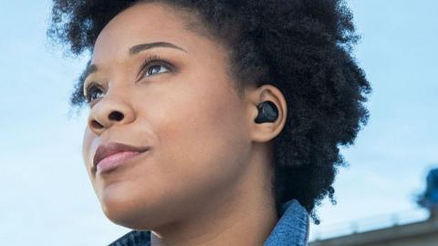 A woman wears Echo Buds