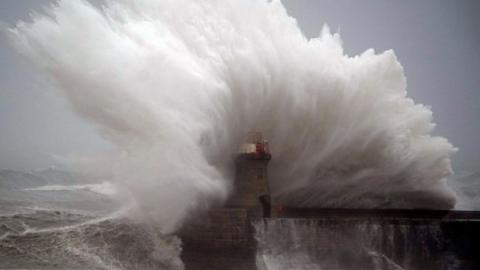 A wave hits South Shields Lighthouse after its dome was removed
