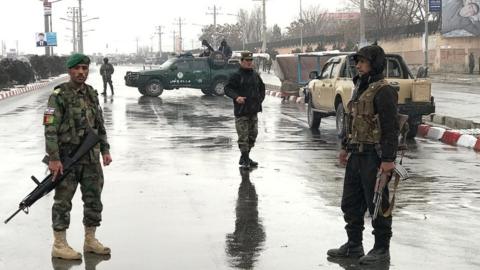 Afghan security forces patrolling a street near the site of the attack