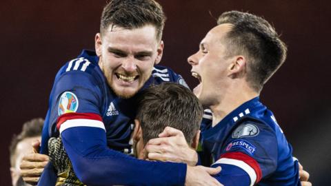 Andy Robertson, David Marshall and Lawrence Shankland celebrate Scotland's shootout win against Israel