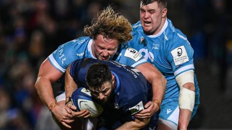 Leinster's Robbie Henshaw is tackled by Tommy Taylor