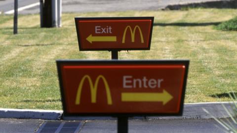 MacDonald's enter and exit signs outside a restaurant