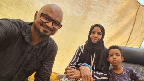 Wathig Ali and his family at the airstrip near Khartoum