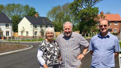 Keith Jenkin (centre) and his wife Lorna and friends decided to build social housing in Lyme Regis