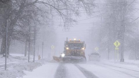 A snowplough on a street in Springville, New York on 23 December 2022