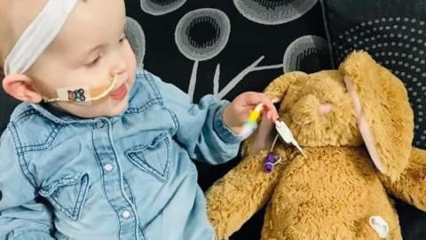 One-year-old Darcey with her tube bunny