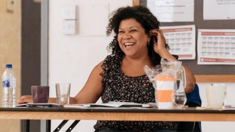 Nancy Medina sat at a desk.