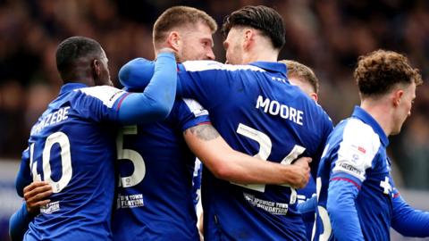Ipswich Town's Cameron Burgess (centre) is congratulated on scoring their second goal of the game by teammate Kiefer Moore during the Sky Bet Championship match at Portman Road, Ipswich
