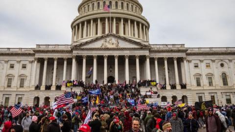 A large group of pro-Trump protesters stand on the East steps of the Capitol Building after storming its grounds on January 6, 2021