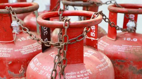 This photo from India's Kochi shows some red cooking gas cylinders chained together