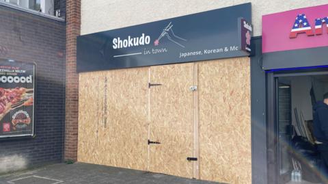 A boarded up shopfront