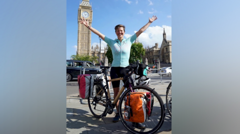 Woman posing in front of bike