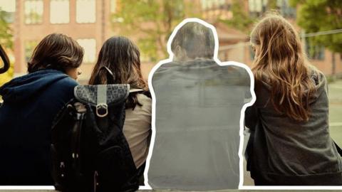 Four schoolchildren sit in a school playground with their backs to the camera. One child has been made to look partially transparent, with a white line outlining their silhouette.