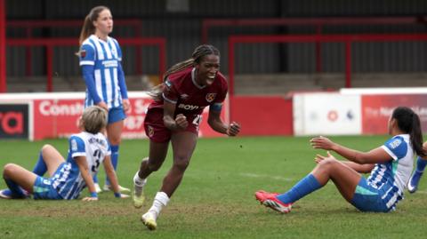 Viviane Asseyi of West Ham United celebrates scoring her team's third goal